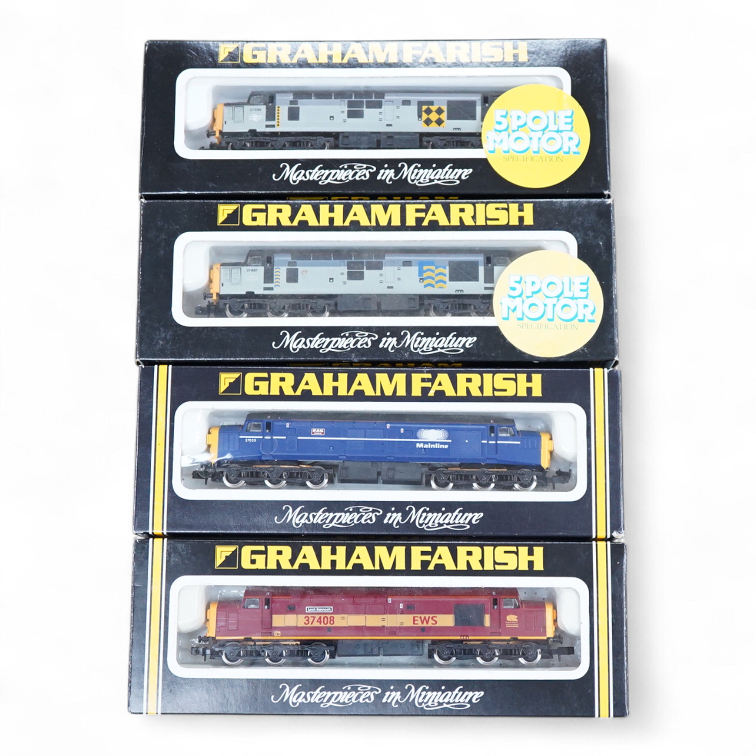 Four boxed Graham Farish N gauge railway Class 37 diesel locomotives; a BR Railfreight, 37 699 (8036), a BR Petroleum Sector, 37 887 (8037), a Mainline, 37055 (803D) and an EWS, 37408 (803E).
